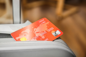 Sticker - Credit card in suitcase on blurred background