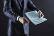 © yurolaitsalbert - closeup of a businessman holding a pen and a document with the terms of the contract.