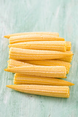 Poster - baby corn on wooden surface