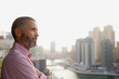 © phocal Media - Expat man with cityscape in the background.