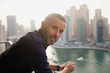 © phocal Media - Portrait of Expat man leaning at balcony.