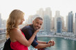 © phocal Media - Couple having fun at balcony.