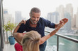 © phocal Media - Couple dancing at balcony.
