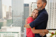 © phocal Media - Couple embracing at balcony.
