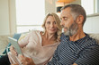 © phocal Media - Couple using digital tablet at home.