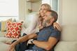 © phocal Media - Couple relaxing on couch.