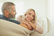 © phocal Media - Couple relaxing on couch.