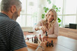 © phocal Media - Couple playing chess.