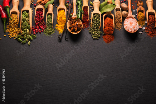 Various spices on black slate. Top view with free space Canvas Print