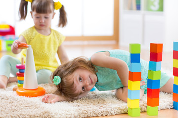 Poster - Children playing with toys in kindergarten