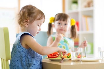 Wall Mural - kids children eating vegetables in kindergarten or at home