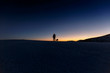 © Connect Images - Silhouetted view of man and dog standing on hill horizon at night
