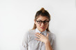 © shurkin_son - Headshot of disgusted female in striped shirt and glasses experiencing hostility to his colleagues in office and condemns her appearance. Hand on chest, raising brows. Negative people expressions
