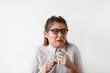 © shurkin_son - Headshot of disgusted Caucasian student girl in shirt and glasses looking aside with fearfyl and suspicions, holding her fist up.Comic portrait of woman having negative emotions and facial expressions