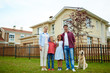 © pressmaster - Happy parents, children and their dog on green grass by new house