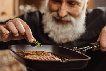 Man cooking steaks