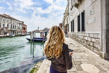 Woman Walking In Murano Island Italy. Traveler Or Tourist Girl Exploring The City