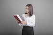 © tonefotografia - Beautiful teacher Woman holding book on grey background