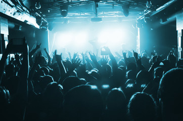 silhouettes of people at a rock festival concert