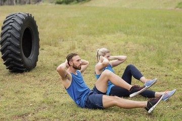 Wall Mural - Fit people performing crunches exercise