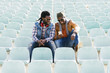 © santypan - Two black race friends having fun with mobile.