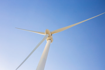 Wind turbine generating electricity with blue sky - energy conservation concept