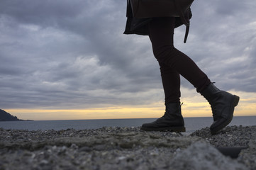 Sunset seascape with legs. Color image