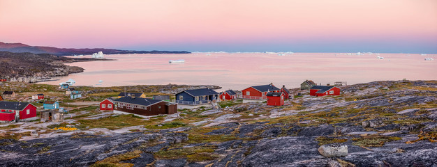 Panoramic views of Disko Bay with icebergs from the village Quaatsut summer night. The source of these icebergs is the Jakobshavn glacier, Greenland