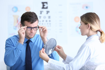 Wall Mural - Young patient visiting ophthalmologist in cabinet