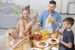 © Africa Studio - Happy family having breakfast on kitchen