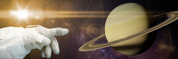 Wall Mural - astronaut pointing to planet saturn