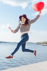 Portrait pretty happy smiling woman with air balloons heart shaped park outdoor