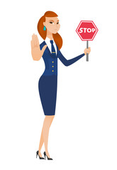 Wall Mural - Caucasian stewardess holding stop road sign.