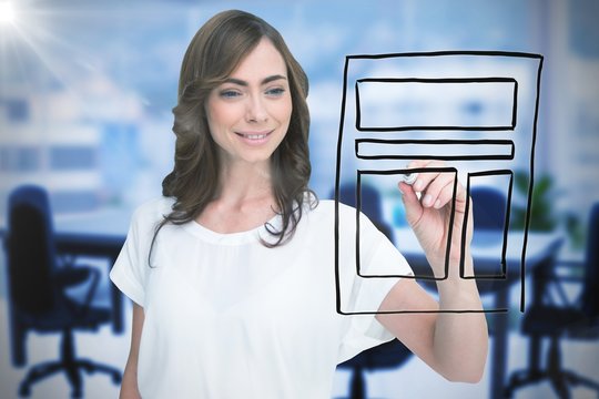 Composite image of smiling businesswoman holding marker