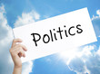 Politics Sign on white paper. Man Hand Holding Paper with text. Isolated on sky background