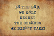 Inspiring motivation quote of in the end we only regret the chances we didn't take with typewriter text. Distressed Old Paper with Typing image.