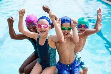 cheerful multi-ethnic children enjoying at poolside