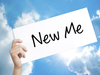 New Me Sign on white paper. Man Hand Holding Paper with text. Isolated on sky background