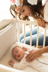 Wall Mural - mother putting baby to sleep