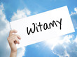 Witamy (Welcome in Polish) Sign on white paper. Man Hand Holding Paper with text. Isolated on sky background.