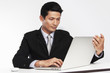 © boonroong - Businessman looking laptop for a business  market worldwide on white background.