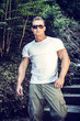 © theartofphoto - Handsome muscular young man outdoor, going down stairs and looking at camera