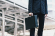 © palidachan - Businessman holding his briefcase in city