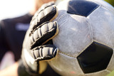 Fototapeta Sport - close up of goalkeeper with ball playing football