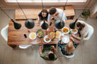© Drobot Dean - Top view of people having dinner together while sitting