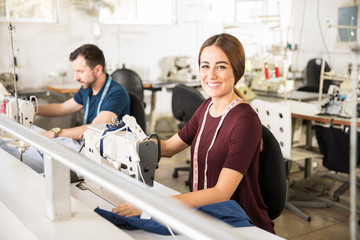 Wall Mural - Pretty woman using a sewing machine