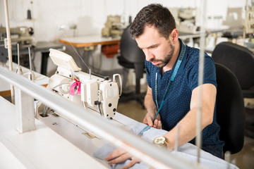 Wall Mural - Tailor measuring some garments