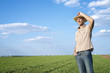 Agriculture. Farmer in the wheat field on a sunny day. Agronomy, faming, husbandry concept. 