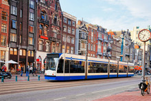 Public Tram Crossing Damrak Main Street Crowded With Tourists Amsterdam