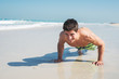 © Dusan Petkovic - Young sporty man exercising at beautiful beach, looking happy.